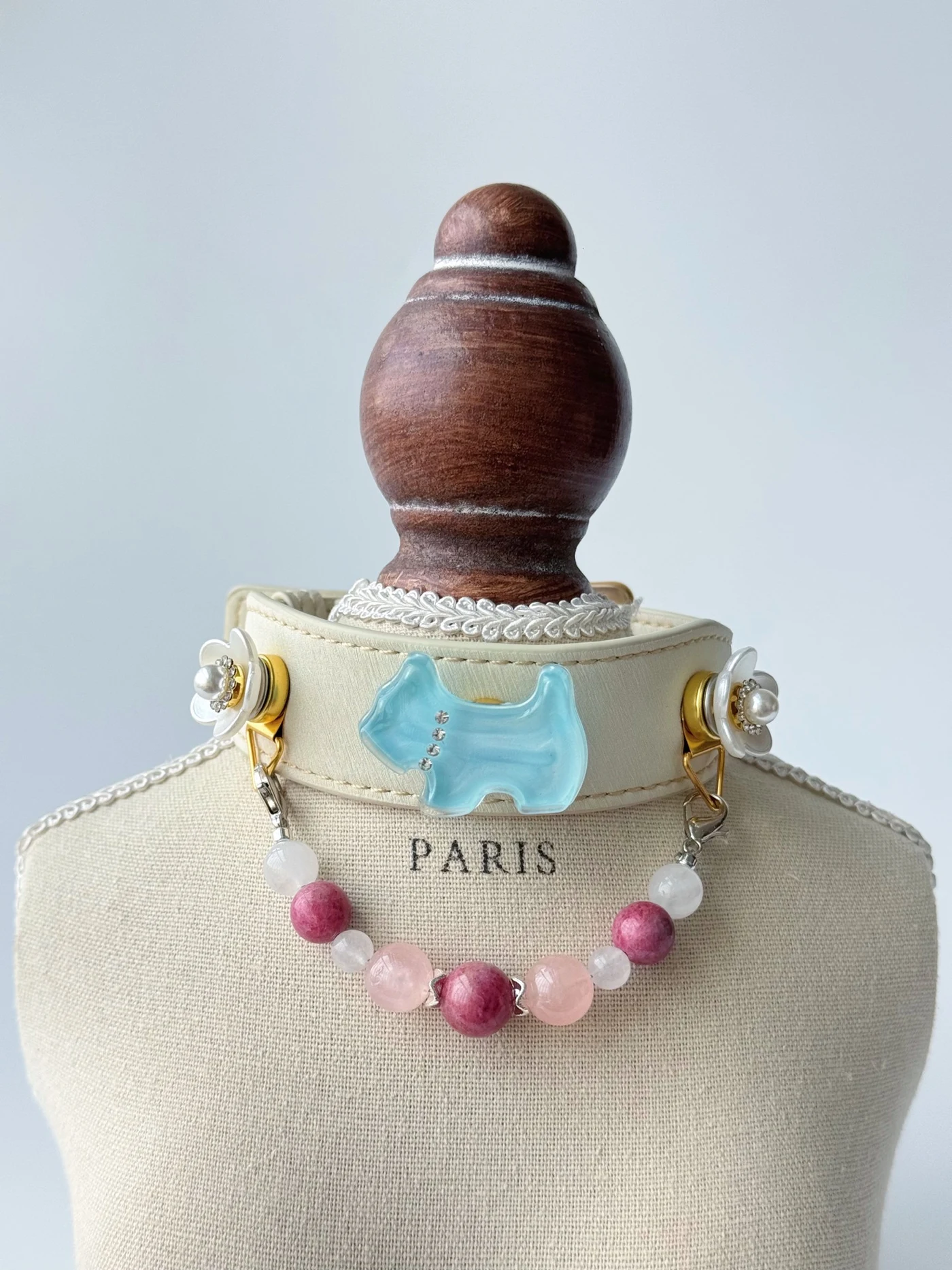Ivory Rose Quartz Garden collar with a blue dog-shaped ornament, white floral accents and a pink and white bead strand